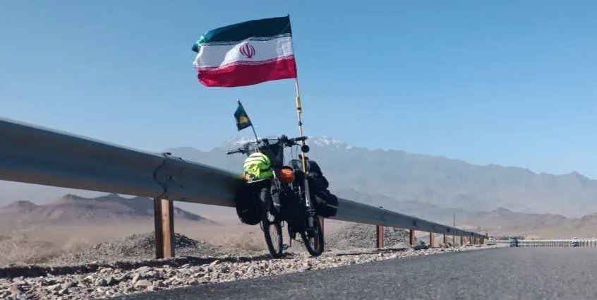 از مزار شهید تا حمایت از قهرمان وطن/ روایت غیرت یک دوچرخه‌سوار کرجی